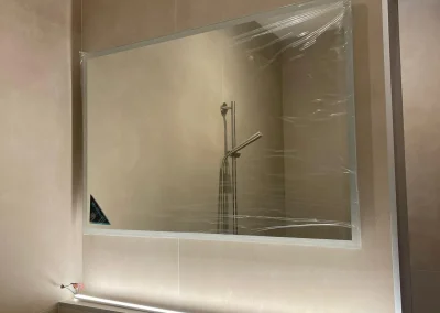 Soft lighting around a bathroom mirror.