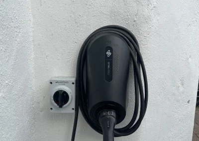 An electric vehicle charger with neatly stored cable.