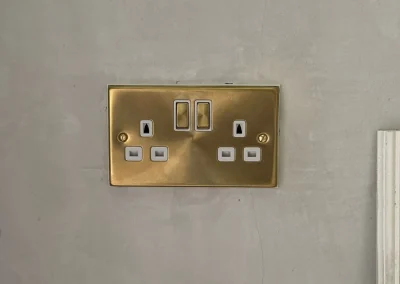 A brass-finish double socket with USB charging ports.