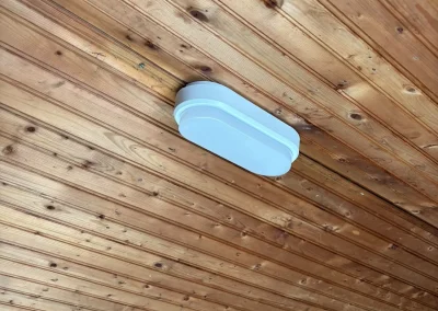 A bulkhead light fitted to a timber ceiling.