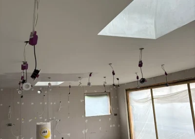 Ceiling downlight installation in progress.