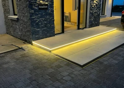 Wall and step lighting creates a welcoming entrance.
