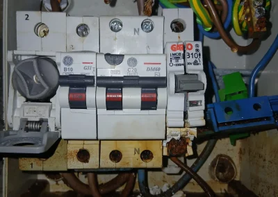 A close-up of an existing electrical board and wiring.
