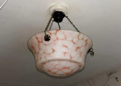 An existing pendant light in an older home.