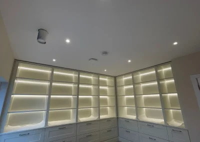 Illuminated shelving brings these fitted cabinets to life.