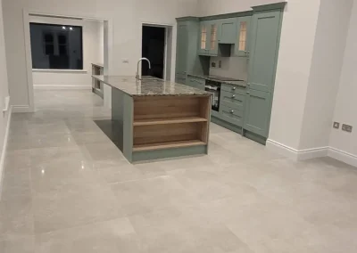 Recessed ceiling lights throughout an open-plan kitchen.
