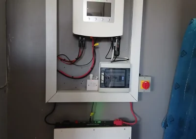 A wall-mounted solar inverter and battery system.