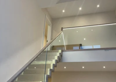 Recessed lighting brightens this modern staircase.